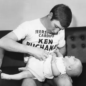 Print of Ken Buchanan with his son Mark during training break, January 1971