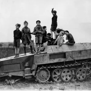 World War 2 1944 Children play on a knocked out German half track armoured vehicle World War 2 1944 Children play on a knocked out German half track armoured vehicle