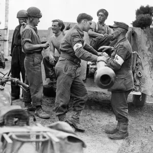 World War 2 August 1944 British and German Red Cross personnel meet over a howitzer World War 2 August 1944 British and German Red Cross personnel meet over a howitzer