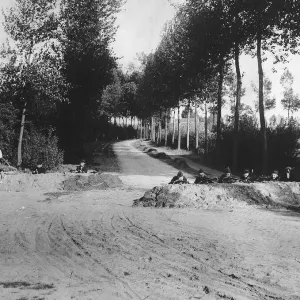 World War One - Belgian soldiers lying behind mounds of earth with guns ready as they