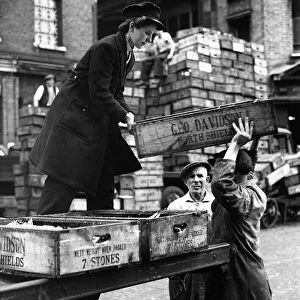 World War Two Home Front. A woman delivery boxes full of fish to traders in Billingsgate