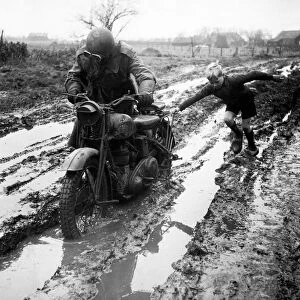 World War II Invasion of Holland A British army dispatch rider stuck in the mud gets a