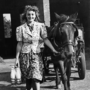 World War II Women. Woman milkman doing the rounds with her horse and cart