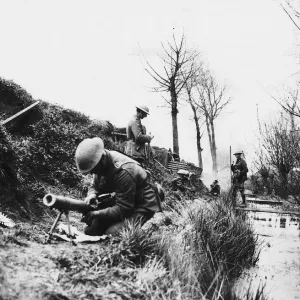 World War One- a British soldier repairs a machine gun in a trench on the British World War One- a British soldier repairs a machine gun in a trench on the British