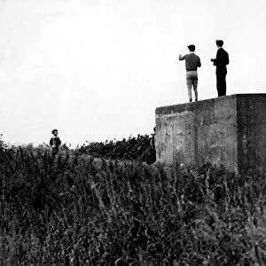 World War Two - Second World War - Children play on a WW2 gun emplacement / pillbox at