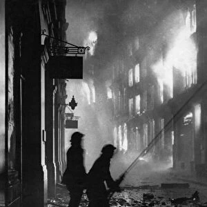 World War Two. London Fire Service fighting a burning building after a bombing raid by