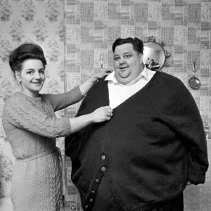 Print of a woman knitting a cardigan for the world's fattest man