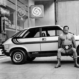 Wrestler Geoff Condliffe known as Count Bartelli lifting a car
