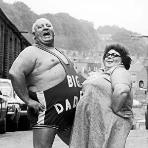 Wrestler Shirley Crabtree alias Big Daddy poses with a fan. 4th September 1980