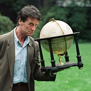 Writer and actor Michael Palin with a globe. 8th October 1992