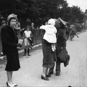 WW2 British Soldiers in England march along the road past families WW2 British Soldiers in England march along the road past families