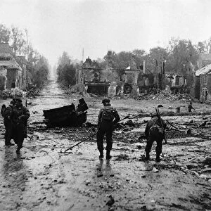 WW2 Royal Engineers clearing mines from the main street in Tilly-Sur-Seulles
