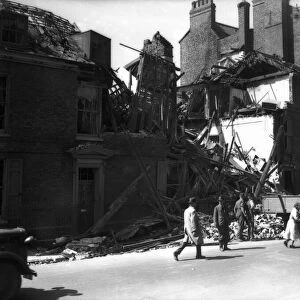 WW2 York Air Raid Bomb Damage Civilians walk pass bomb damaged housing in York as