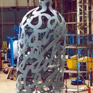 Yard electrician Peter Gilpin is dwarfed by the huge 35 foot metal bottle ordered by Yard electrician Peter Gilpin is dwarfed by the huge 35 foot metal bottle ordered by