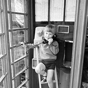 Five year old Andrew Butler, complete with a mini-stepladder, phones his girlfriend