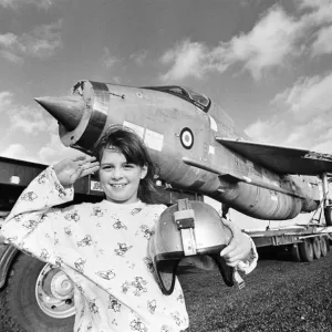 Eight year old Cheryl James poses beside a T55 Lightning fighter jet Eight year old Cheryl James poses beside a T55 Lightning fighter jet