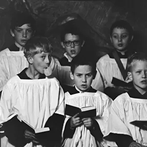 Ten year old choirboy Ian Stacey of Bethnal Green tries to break the concentration of his