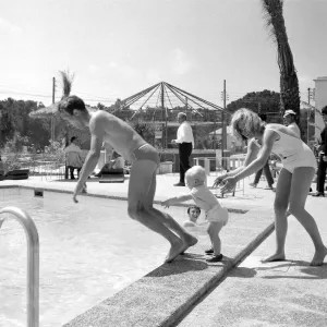 Two year old Gregory Curtis with his mother Jill on holiday in Majorca pushing his dad