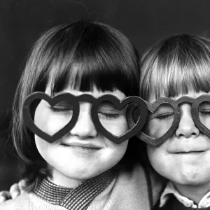 Four year old Sheldon Neal (right) and Terry Green, wearing love heart shaped glasses at