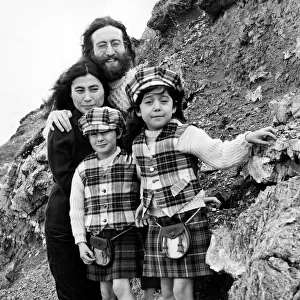 Yoko Ono and John Lennon stand on mountain side with Julian Lennon and Kyoko