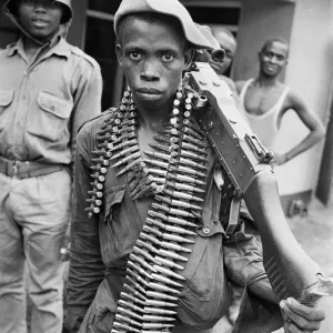 A young Biafran soldier seen here posing with a heavy machine gun A young Biafran soldier seen here posing with a heavy machine gun
