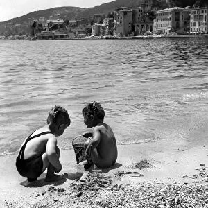 Young boy and girl playing on the beach at Villefranche, Alpes Maritime, France