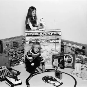 A young boy and girl with a selection of childrens toys for Christmas. December 1980 A young boy and girl with a selection of childrens toys for Christmas. December 1980