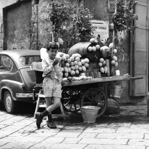 A young boy of Naples in Southern Italy selling goods on the side of the road A young boy of Naples in Southern Italy selling goods on the side of the road