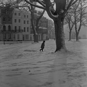 Print of a young boy pulling his sledge up Sion Hill in Bristol, 1962 Print of a young boy pulling his sledge up Sion Hill in Bristol, 1962