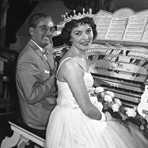 Young bride sitting at a wurliitz organ with musician for her wedding ceremony at