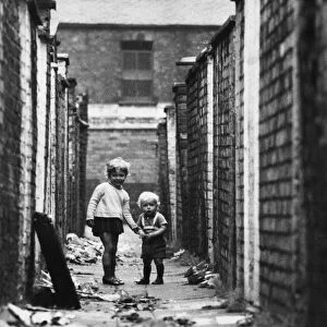 Young children play in the back alleyways behind Clifton Street in Ordsall, Salford