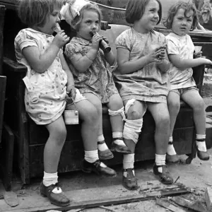 Young children surrounded by bomb damage on St Marys Road, Edmonton July 1944