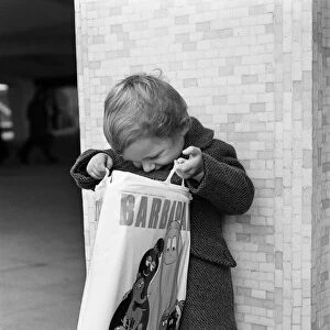 A Young Christmas shopper in Birmingham, West Midlands. 20th December 1975