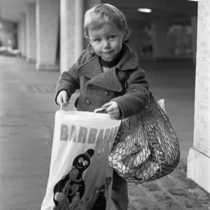 A Young Christmas shopper in Birmingham. 20th December 1975 A Young Christmas shopper in Birmingham. 20th December 1975