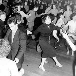 Young dancers crowd the floor for a rock n roll dance