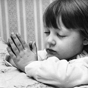 Young Denise Woodhouse praying like a little angel