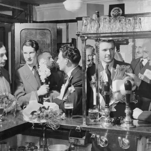 Young Fathers in the Pub June 1954 New fathers with their bouquets of flowers have