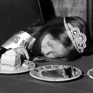 A young girl fall asleep on the table whilst eating a peice of cake - Childrens A young girl fall asleep on the table whilst eating a peice of cake - Childrens