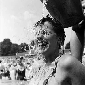 Young girl keeps cool during the hot weather. July 1952 C3326