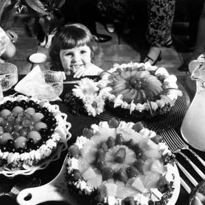 A Young Girl Admires Vintage Cakes Print Circa 1970 A Young Girl Admires Vintage Cakes Print Circa 1970