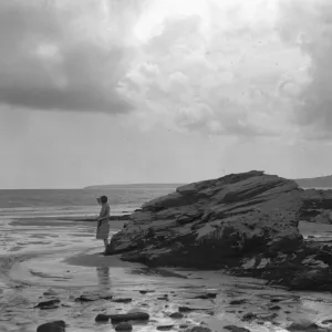 A young girl seen here on the beach near Par, Cornwall. August 1927 132a