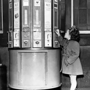 A young girl at a vending machine on Newcastle Central Station in 1954 A young girl at a vending machine on Newcastle Central Station in 1954