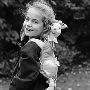 A young girl wearing a soft toy rucksack. 21st October 1986