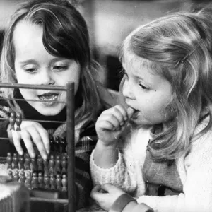 These young girls learn the art of calculating with the help of a abacus