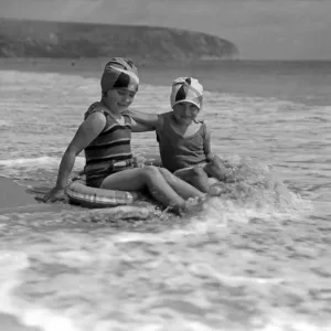 Two young girls in the sea at Swanage, Dorset. July 1933