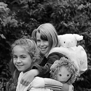 Two young girls wearing soft toy rucksacks. 21st October 1986