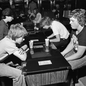 Young holidaymakers play the video machines at the James Corrigan seafront amusement