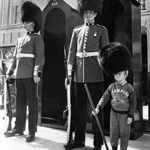 This young lad has volunteered to to help out the Coldstream Guards when they set up a