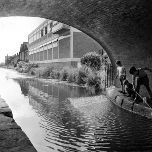 These young lads are having fun fishing with a net in the Coventry Canal at the Cash