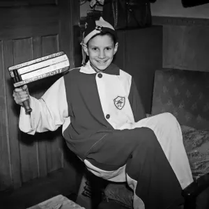 Young Leicester City football club mascot holding his rattle wearing his costume